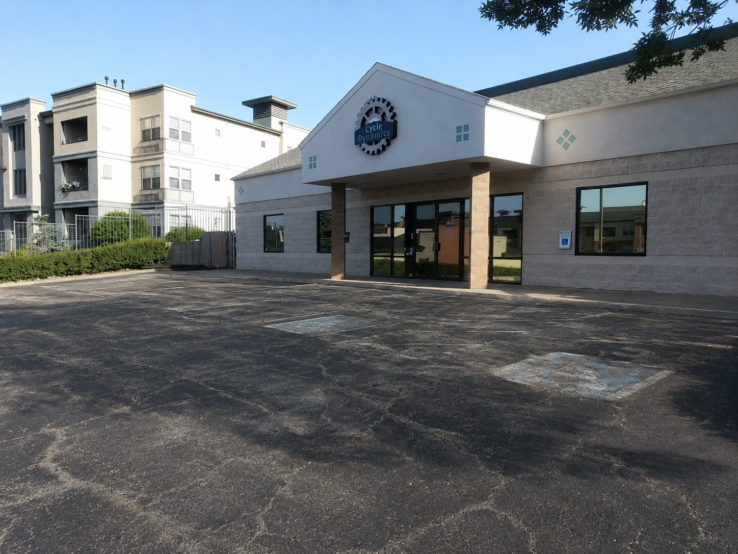 Faded commercial parking lot before Sunshine Striping Solutions re-striping
